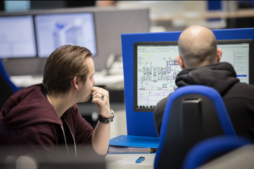 Engineers reviewing equipment schematic