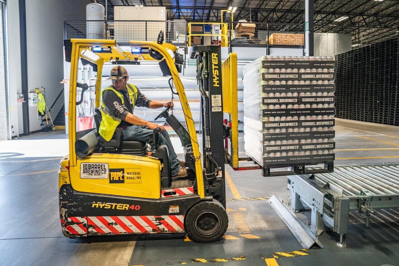 Operator Moving Beer Cases for Distribution