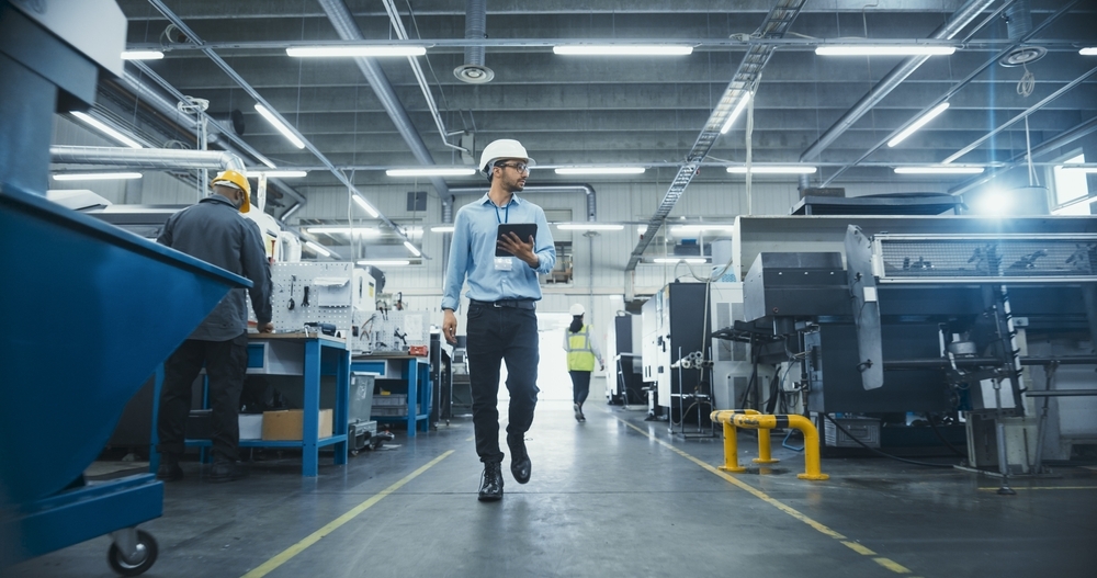 engineer walking through manufacturing facility